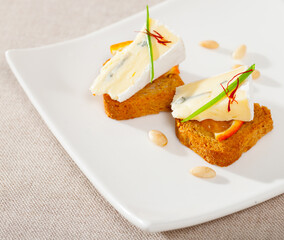 Tasty canape with soft blue cheese and orange