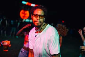 Young man enjoying nighttime music festival