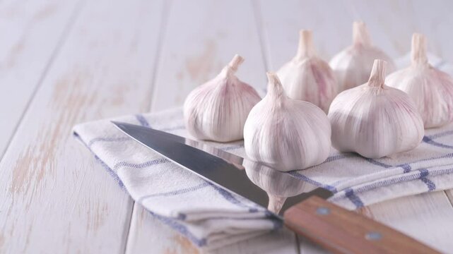 garlic on a white kitchen table.
organic garlic on a white wooden table.