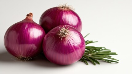 This image showcases a trio of fresh red onions beautifully displayed with rosemary, highlighting their vibrant colors and textures for a delightful culinary presentation.