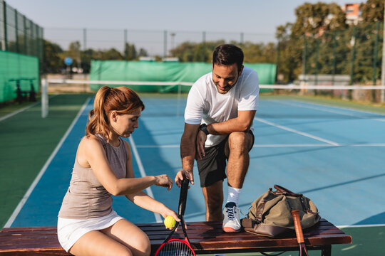 Young couple playing tennis outdoors enjoying a fun summer game