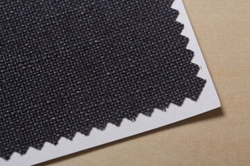 Blue woven fabric swatch texture close-up on a birch wood panel for background or design element