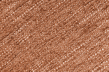 Orange Jacquard fabric with large loose diagonal woven, coarse weave texture upholstery cloth. Textile background, furniture textile material, wallpaper, backdrop. Cloth structure close up, macro.