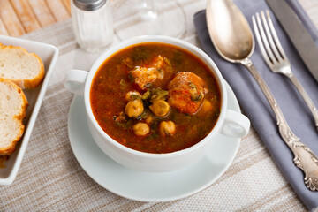 Hearty traditional Spanish soup with beans, chickpeas and meat
