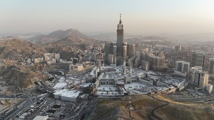 Naklejka premium Mecca , Saudi Arabia Mars 30 2024: Makkah city Streets hotels and transportation Makkah Clock Tower - Masjid Al Haram drone aerial view
