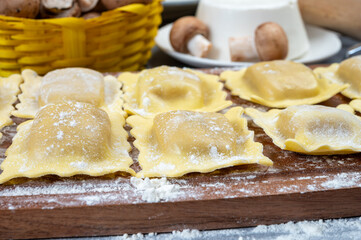 Italian food, fresh home made stuffed pasta ravioli dumplings with ricotta soft cheese and champignons porcini mushrooms, Parma, Emilia Romagna, Italy