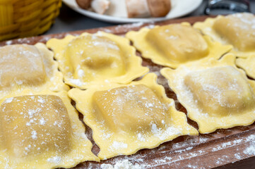 Italian food, fresh home made stuffed pasta ravioli dumplings with ricotta soft cheese and champignons porcini mushrooms, Parma, Emilia Romagna, Italy