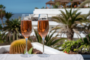 Celebration, birthday party, drinking of rose cava or champagne sparkling wine in vacation resort Costa Adeje, Tenerife, Canary islands winter sun vacation, Spain