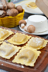 Italian food, fresh home made stuffed pasta ravioli dumplings with ricotta soft cheese and champignons porcini mushrooms, Parma, Emilia Romagna, Italy