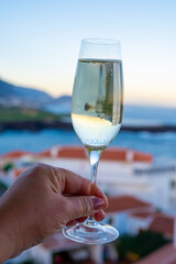 Celebration, birthday party, drinking of cava or champagne sparkling wine in vacation resort Costa Adeje, Tenerife, Canary islands winter sun vacation, Spain