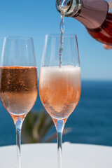 Celebration, birthday party, drinking of rose cava or champagne sparkling wine in vacation resort Costa Adeje, Tenerife, Canary islands winter sun vacation, Spain