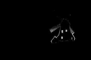 Silhouette of a Windmill at Night