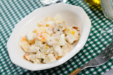 Delicious salad with chicken fillet, pineapple and eggs, dressed with yogurt sauce