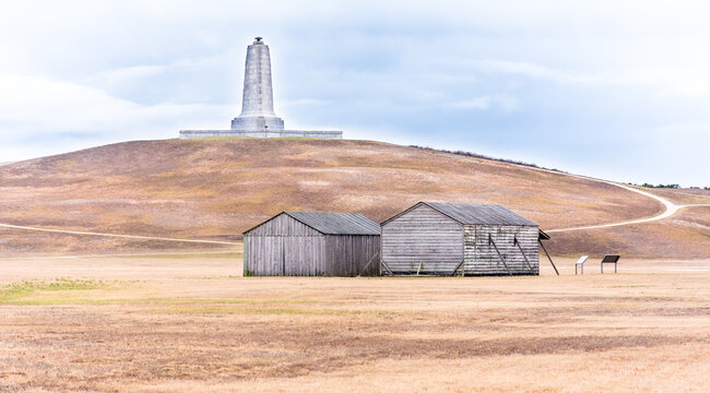 Kitty Hawk, NC - USA: Wright Brothers National Memorial showing the two wooden Wright workshops and hanger below monument on kill devil hills