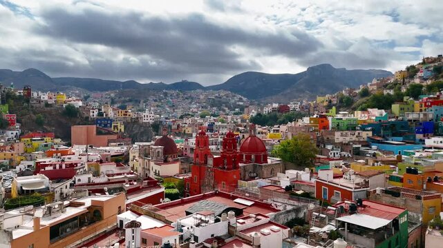 Churches of San Francisco and Santa Casa de Loreto in the historic downtown of Guanajuato, Mexico. Drone camera flies over the city towards the churches