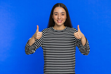 Like. Caucasian woman raises thumbs up agrees with something or gives positive reply recommends...