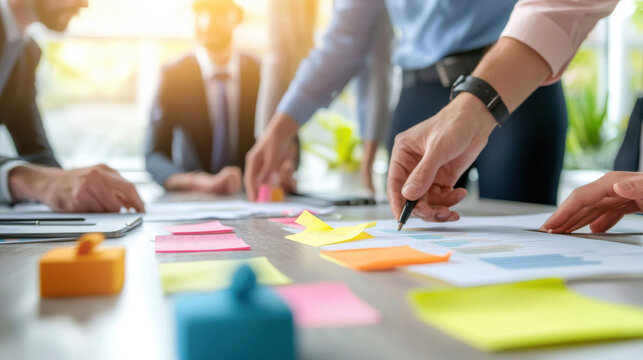 Collaborative business professionals engaged in role playing exercise, analyzing data and discussing strategies