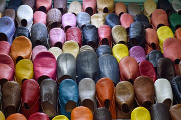 Front view of Slippers or sandals of many colors hung from street stalls