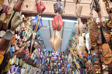 Slippers or sandals of many colors hung from street stalls in Marrakech's souk
