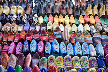Front view of Slippers or sandals of many colors hung from street stalls