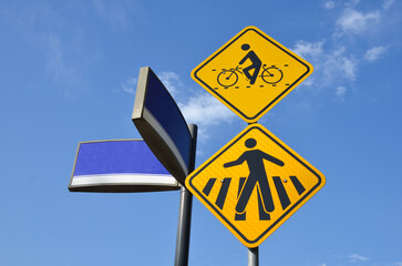 Three essential signs: Signaled Cyclist Crossing, Pedestrian Crossing and street identification....