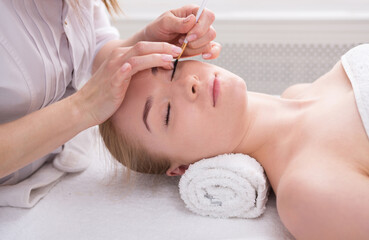 Eyelashes tinting and coloring, spa beauty treatment and skincare. Woman getting procedure by beautician at spa salon, close-up