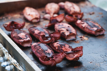 Ikayaki, Grilled roasted Squid with sauce - popular Japanese Street Food, variety of different traditional food snack selection in Tokyo, Japan, street market with local vendor stalls cooking