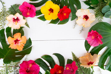 Tropical frame of flowers and leaves, summer vacational background