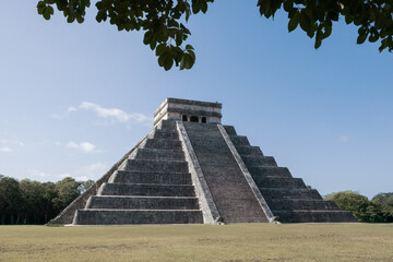 Wide angle on the Chichen Itza, leaves in the foreground