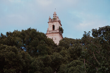 View on a church bell tower surrounded with trees