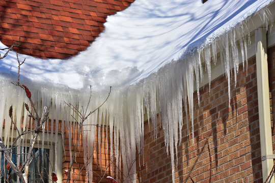 Ice dams in roof gutters from melting snow can cause water damage inside home, insufficient attic insulation is usually the cause.