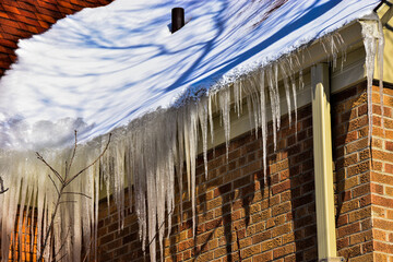 Ice dams in roof gutters from melting snow can cause water damage inside home, insufficient attic insulation is usually the cause.