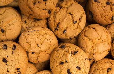 Cookies background. Chocolate chips biscuits texture background. Fattening sweets concept