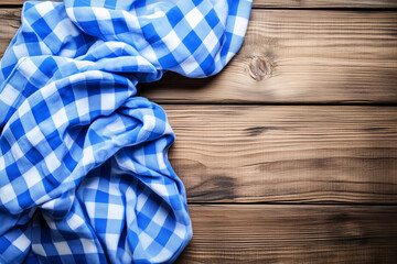 Fototapeta premium Blue and White Checkered Tablecloth on Rustic Wooden Background Capturing Cozy Atmosphere
