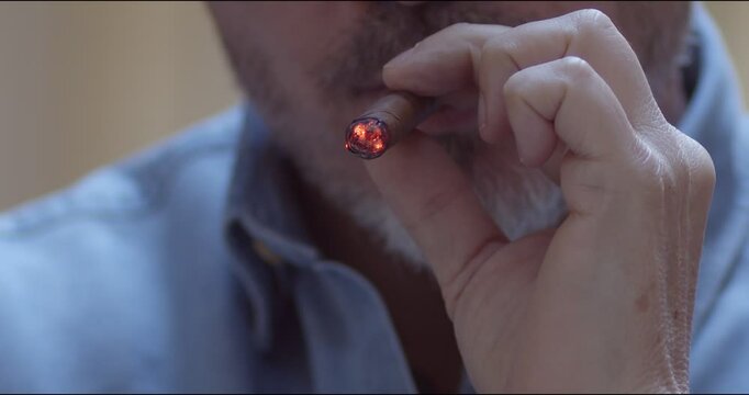 Man smoking cigar - slow motion close up video. Copy space.