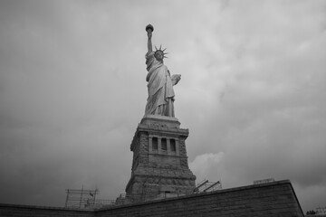 Close-up view of the Statue of Liberty in New York City, highlighting its iconic torch and face, from low angle,