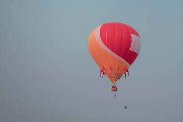 Close up on a hot-air ballon flying, others hot-air ballons in the background