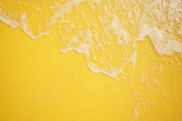 Obraz premium Yellow Surface with Receding Foamy Water