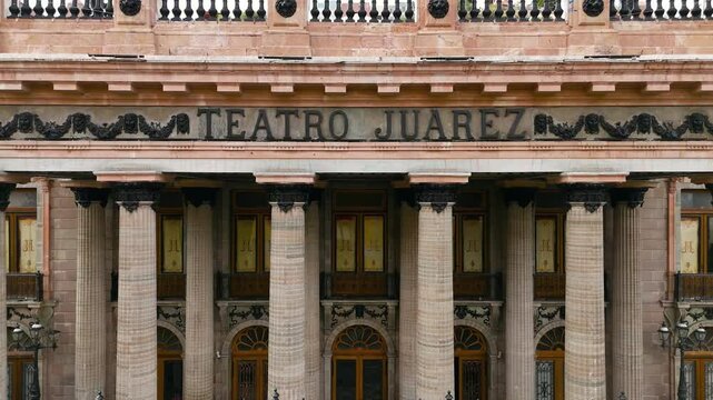Juarez Theater in the historic downtown of Guanajuato, Mexico. Drone camera hovering in front of the theater with the Pipila monument and funicular in the background