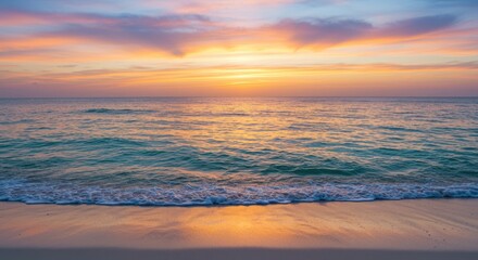 Obraz premium Serene sunset over calm ocean waves on sandy beach