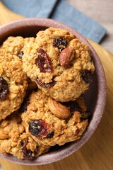 Delicious oatmeal cookies with raisins and nuts on table, top view