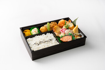 Makunouchi Bento: A Traditional Japanese Lunchbox Featuring a Variety of Dishes Including Rice, Grilled Fish (Salmon), Tamagoyaki (Sweet Rolled Omelet), Tempura (Fried Dishes), Pickled Vegetables, and
