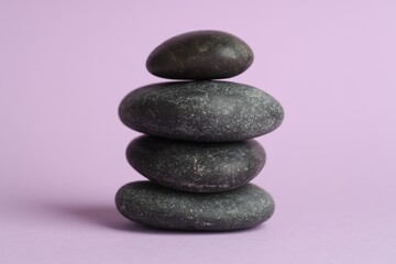 Stack of rocks on lilac background. Harmony and life balance