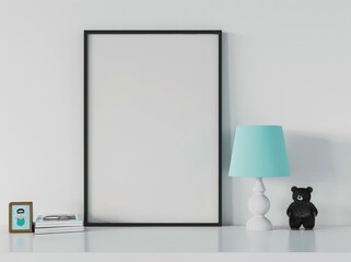 A black frame mockup on a white table with a blue lamp. a stack of books. a small wooden frame and a teddy bear