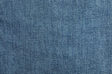 Texture of blue jeans as background, top view