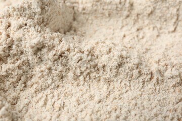 Brown rice flour as background, closeup view