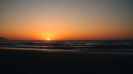 Sunset over ocean, golden sky, silhouetted horizon, calm waves, beach shoreline, serene atmosphere, warm colors, gradient sky, peaceful seascape, dusk scenery, minimalist landscape, tranquil evening, 