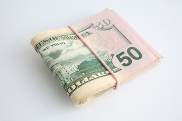 One packs of 50 fifty dollar bills snug a rubber