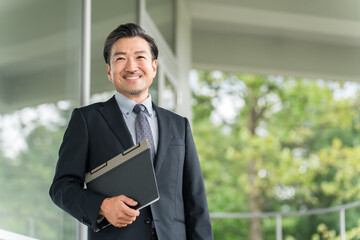 Fototapeta premium 学校の廊下を移動する教員・教師の男性（高校・中学校） 