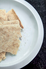 Casabe, venezuelan bread made from bitter cassava or yucca, resting on white plate